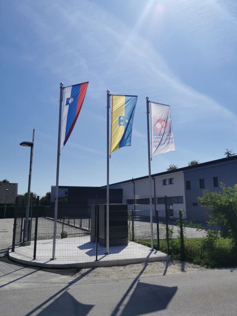 Pokončne izobešene zastave Slovenije, Celja in Občinske zveze Celje — Reklama Celje